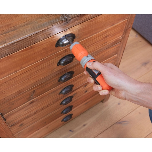 BLACKDECKER BCF602C orange cordless screwdriver used on wood drawer handle