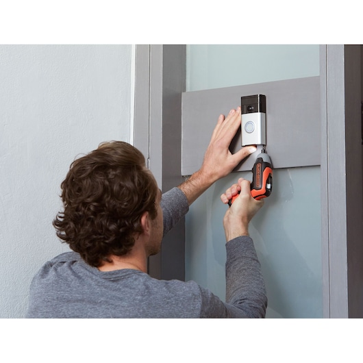 BLACKDECKER BCF611CK cordless screwdriver used to install doorbell, indoor scene.