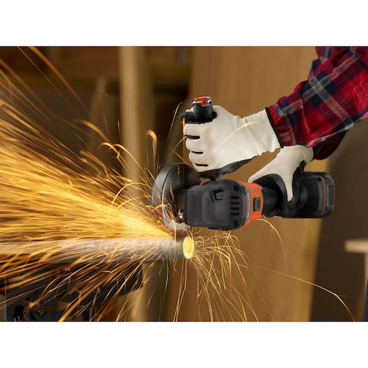 Photo of BLACKDECKER BCG6L8D1S cordless angle grinder cutting metal pipe, sparks flying, worker wearing gloves.
