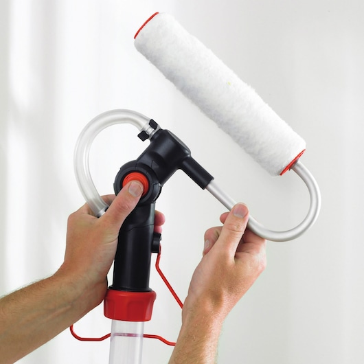 BLACKDECKER BDPR400 paint roller with black and red handle and attached paint tube, close-up in hand.