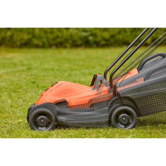 Side view of BLACKDECKER BEMW451BH lawn mower on grass, showing adjustable handle positions.