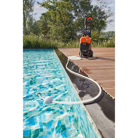 BLACKDECKER BEPW2000 pressure washer with hose in use by a swimming pool on a wooden deck, outdoor angle