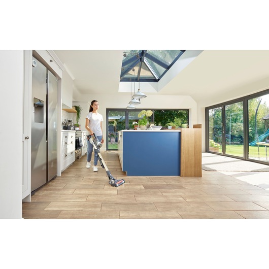 BLACKDECKER BHFEV36B2D cordless stick vacuum cleaner used on kitchen tiles near blue island.