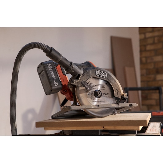 BLACK+DECKER BLCCS78N cordless circular saw with 24T blade cutting wood, close-up side angle.