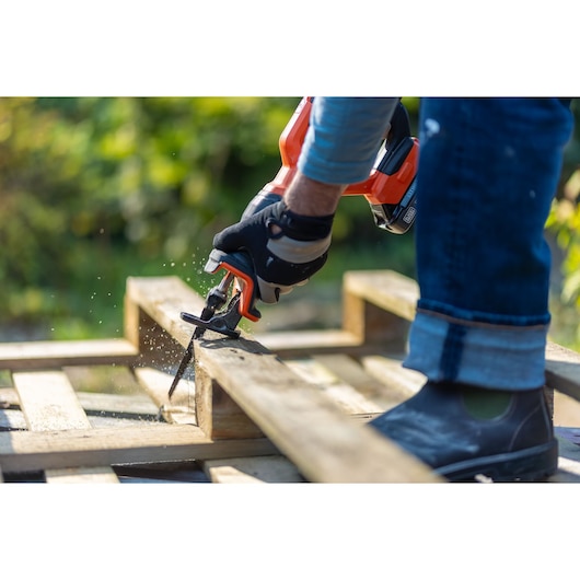 BLACKDECKER BLCR78N reciprocating saw cutting wood outdoors, close-up photography.