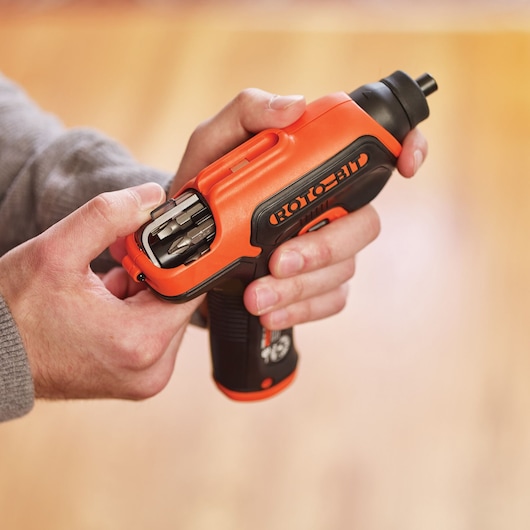 BLACKDECKER CS36BSC cordless screwdriver with integrated bit storage held in hand, close-up view.