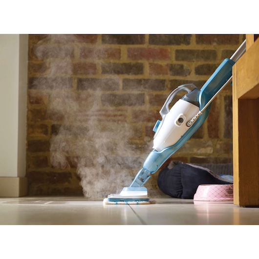 BLACKDECKER FSMH1321 steam mop cleaning tiled floor, side view, with visible steam emission.