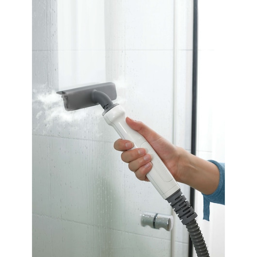 BLACKDECKER FSMH1321 steam cleaner nozzle cleaning glass shower tiles, close-up view.