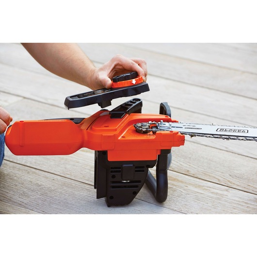 Photo of BLACKDECKER GKC3630L20 cordless chainsaw with cover removed, showing chain area during maintenance.