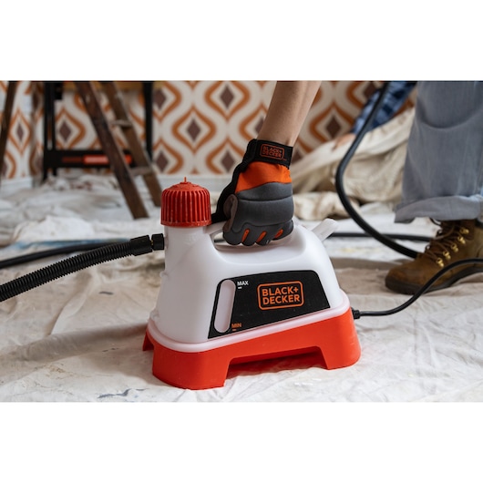BLACKDECKER KX3300 steam cleaner with red base and hose, photo during indoor use.
