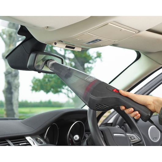 BLACK+DECKER NVB12AVA handheld vacuum cleaning car rearview mirror, close-up inside vehicle.