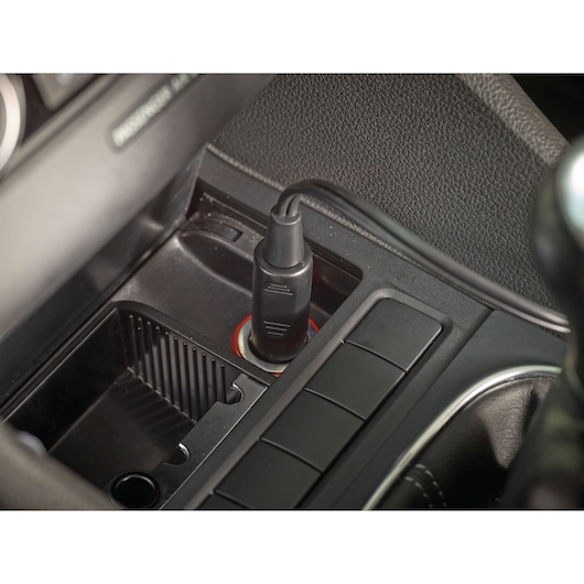 BLACK+DECKER PD1200AV car adapter plugged into a vehicle power outlet, close-up angle.