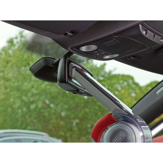 BLACKDECKER PV1200AV handheld car vacuum cleaning around rearview mirror, close-up angle.