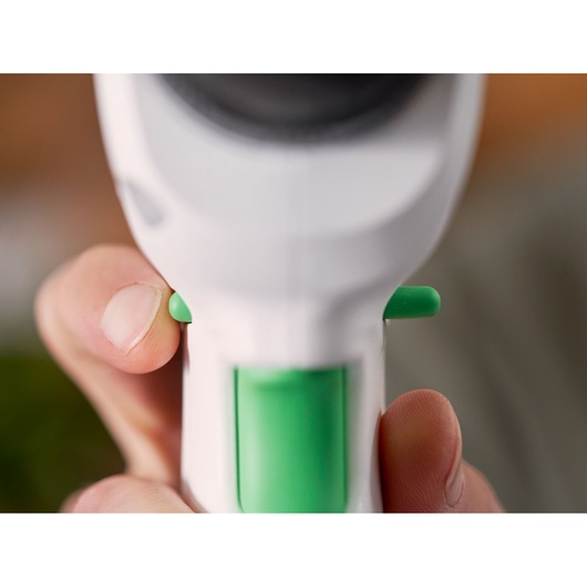 Close-up photo of BLACKDECKER REVDD12C white and green tool handle with trigger buttons.